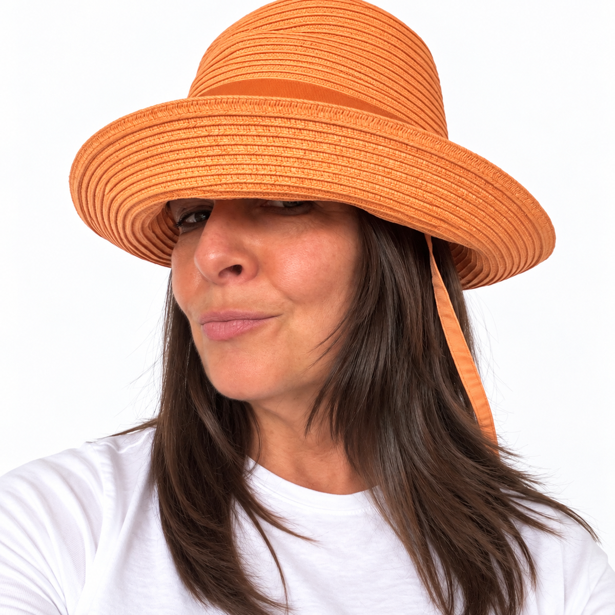 Angled view of the Just Cruising Feeling Peachy sun hat, highlighting its relaxed brim and tonal leather trim.