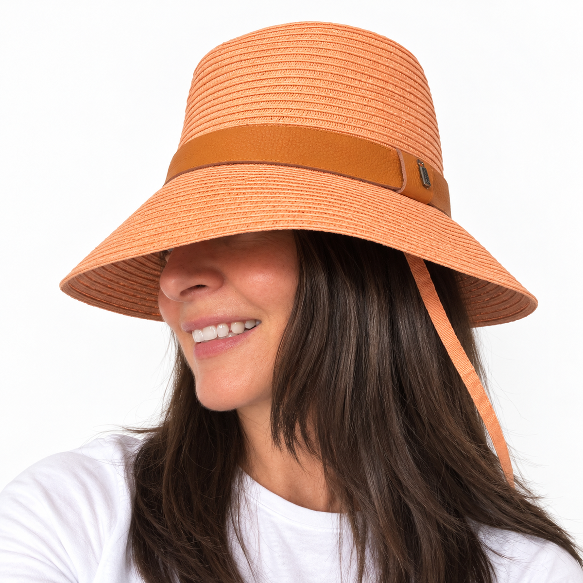 Side view of the Just Cruising Feeling Peachy sun hat, showing its paper ribbon weave, shaped brim and leather band.