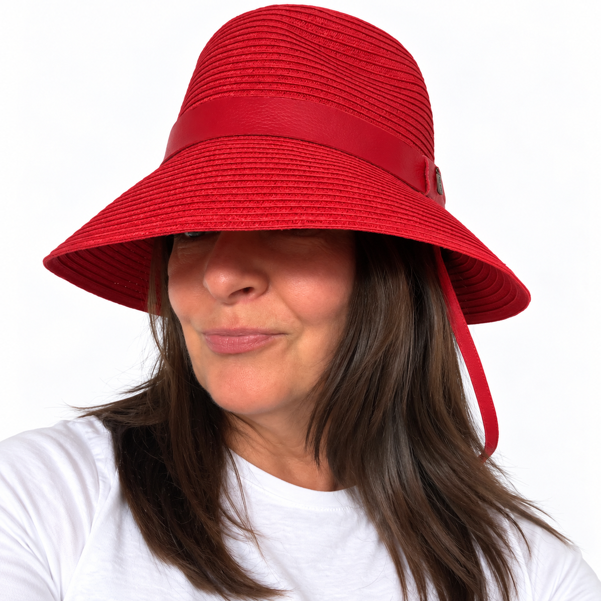 Just Cruising So Racy red paper ribbon sun hat worn with the brim down.
Copy alt text
