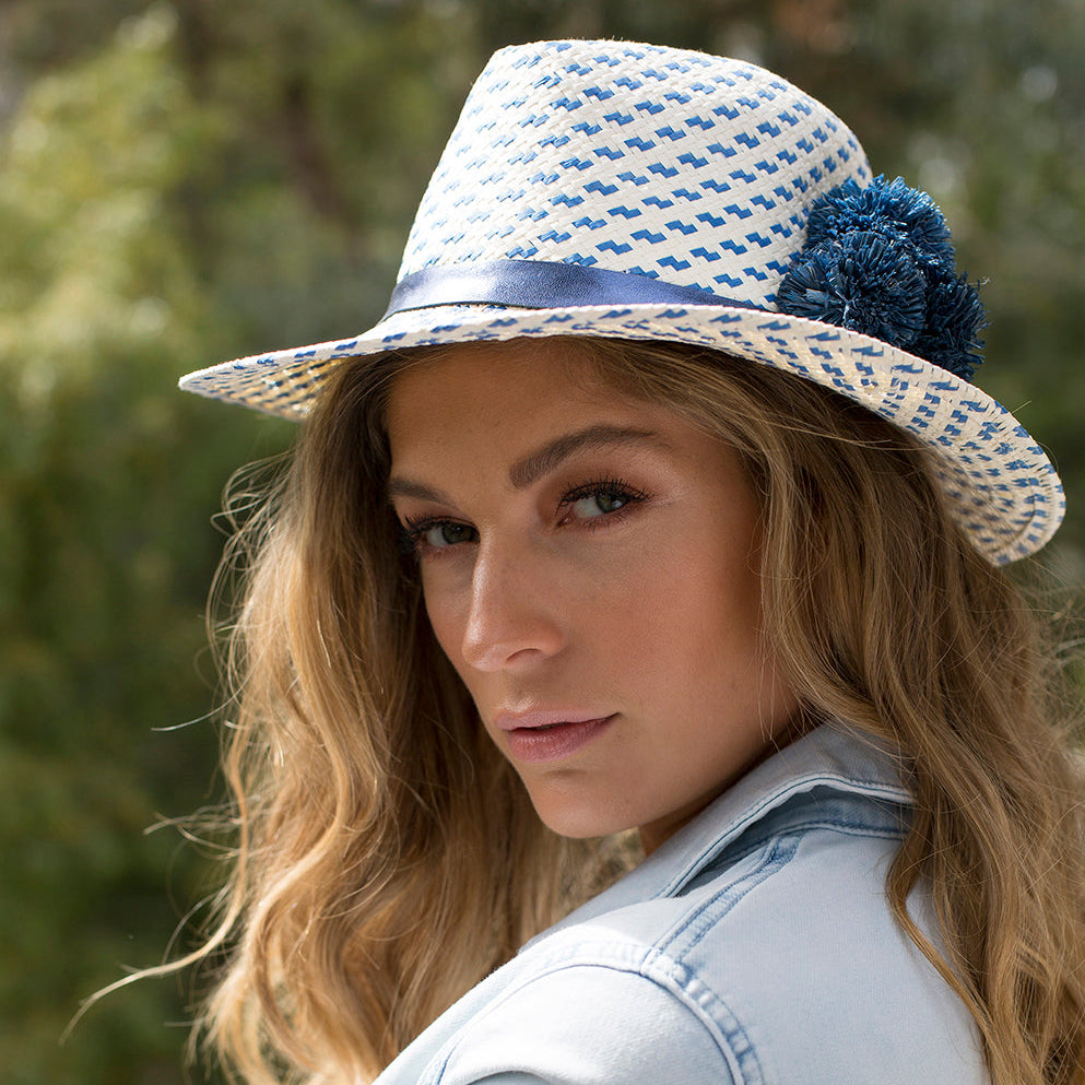 Woman wearing OUT of the BLUE blue and white handwoven paper ribbon hat