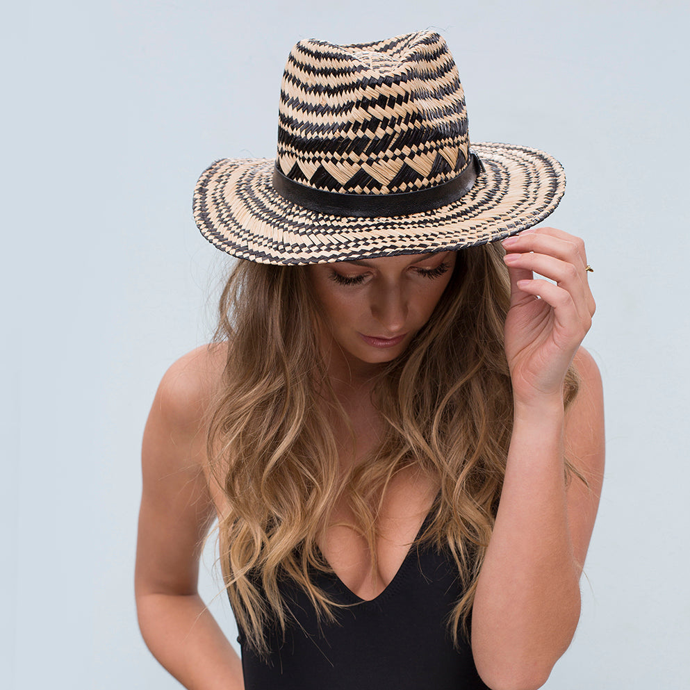 Summer Lovin’ handwoven raffia hat with leather band worn by a w