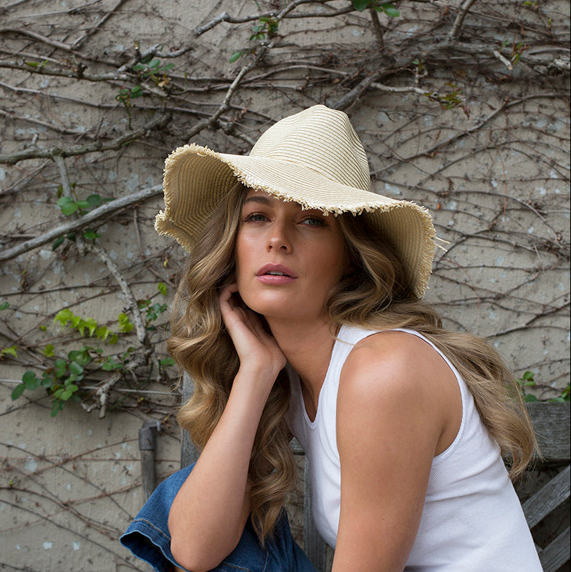 Fringed FIESTA paper hat with wide brim worn outdoors