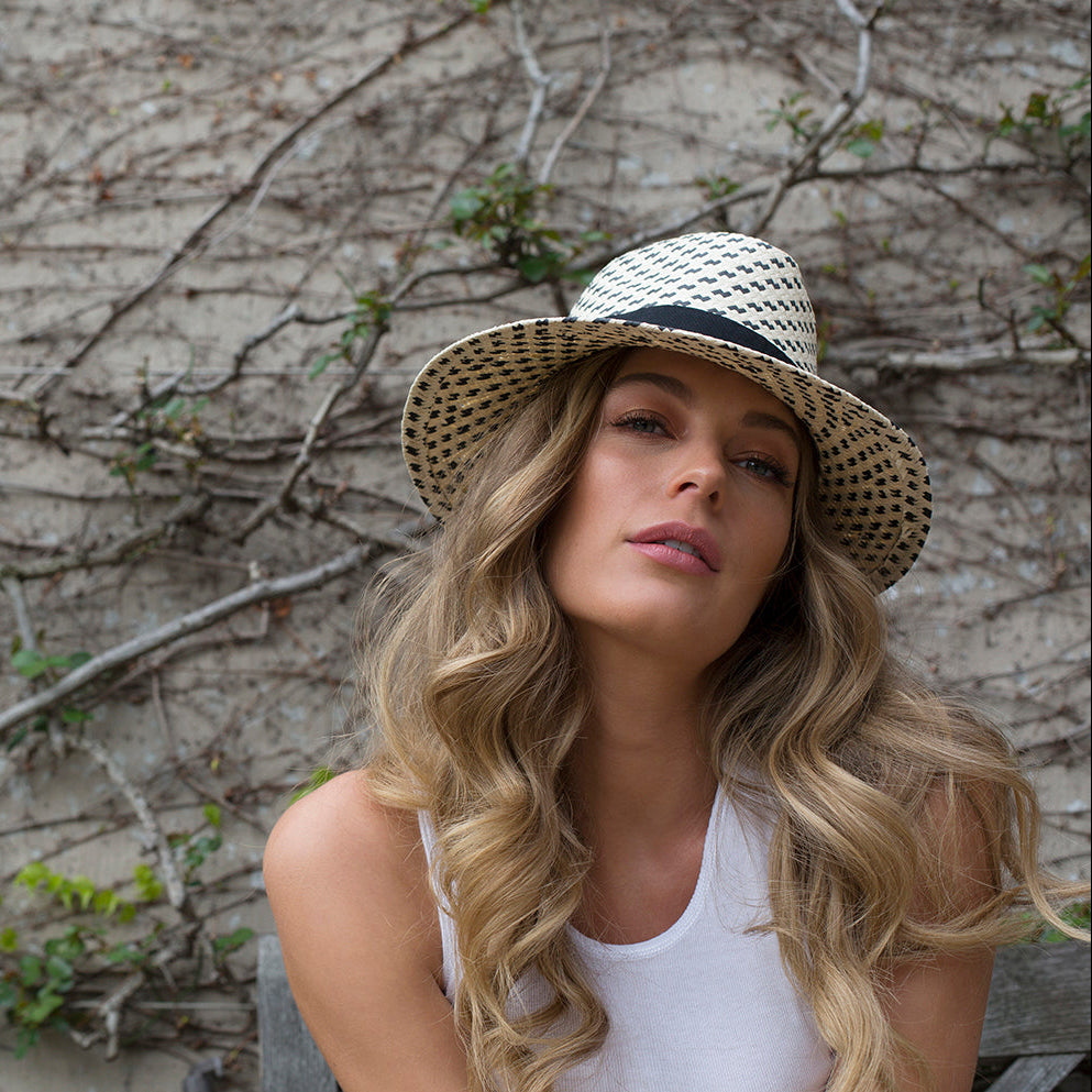 Salt and Pepper handwoven paper sun hat worn by a woman outdoors