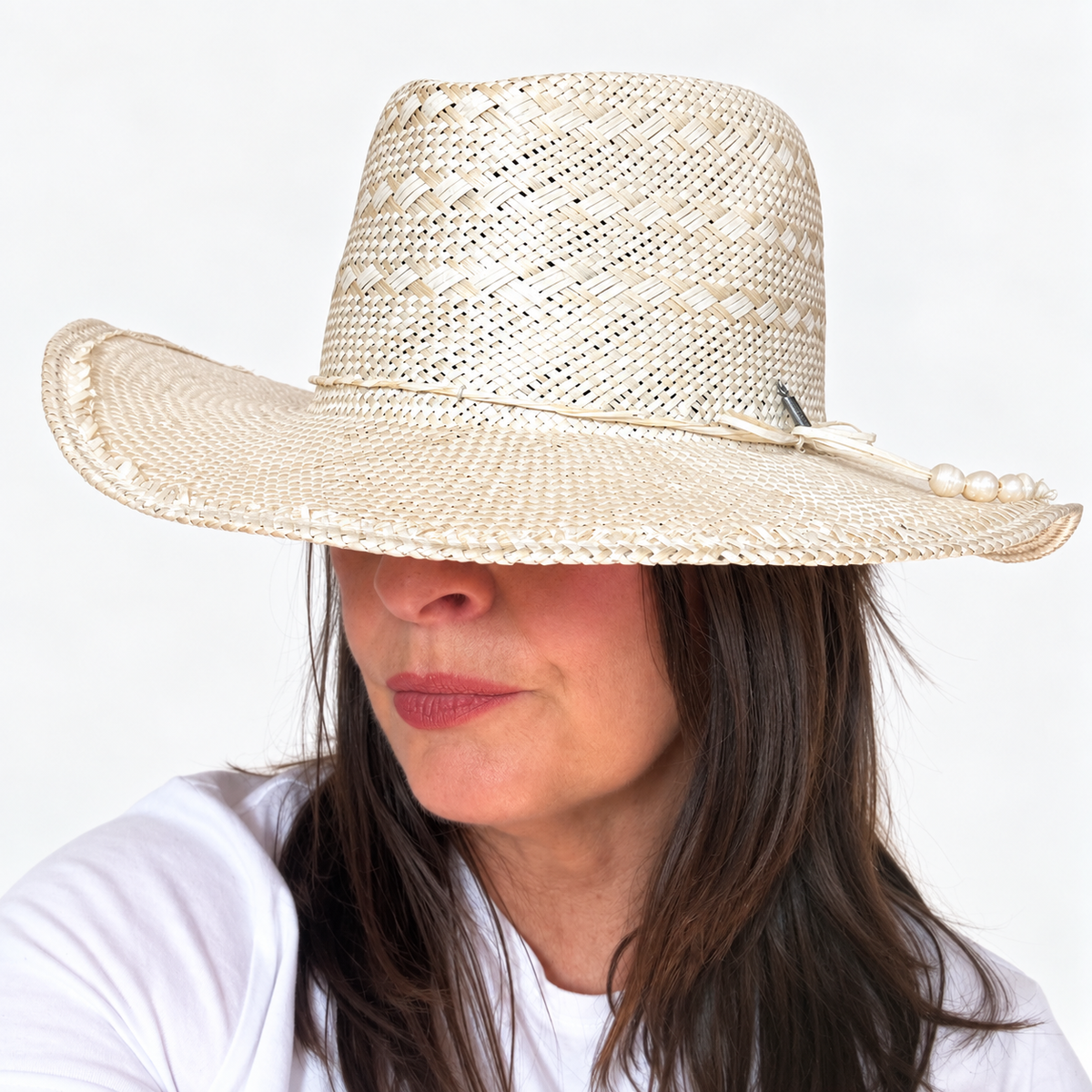 Sun-Kissed Creama wide brim straw hat with pearl embellishment worn by brunette woman
