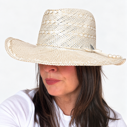 Sun-Kissed Creama wide brim straw hat with pearl embellishment worn by brunette woman