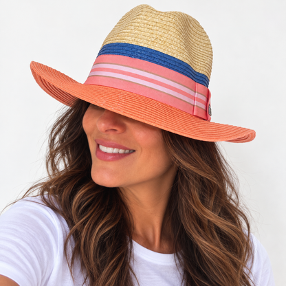 Miami Peach natural and peach paper hat with striped grosgrain ribbon worn by woman