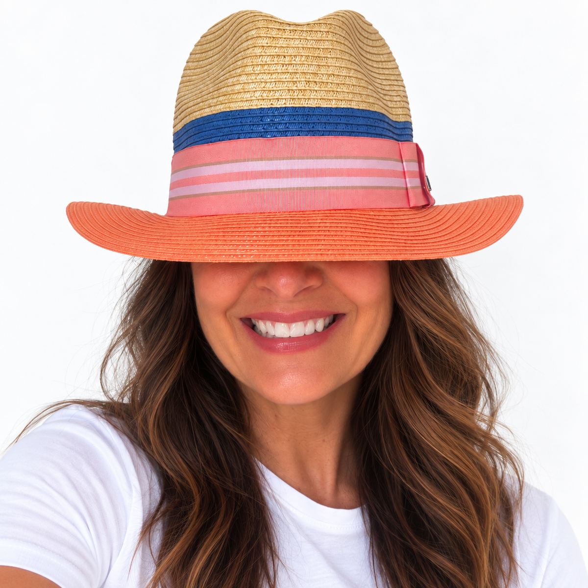 Miami Peach natural and peach paper hat with striped grosgrain ribbon worn by woman with big smile and white teeth