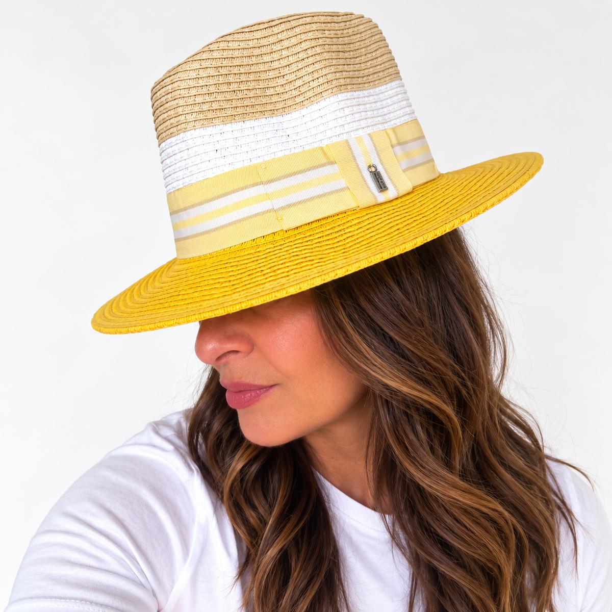 Woman wearing Here Comes The Sun yellow and natural sun hat, side view
