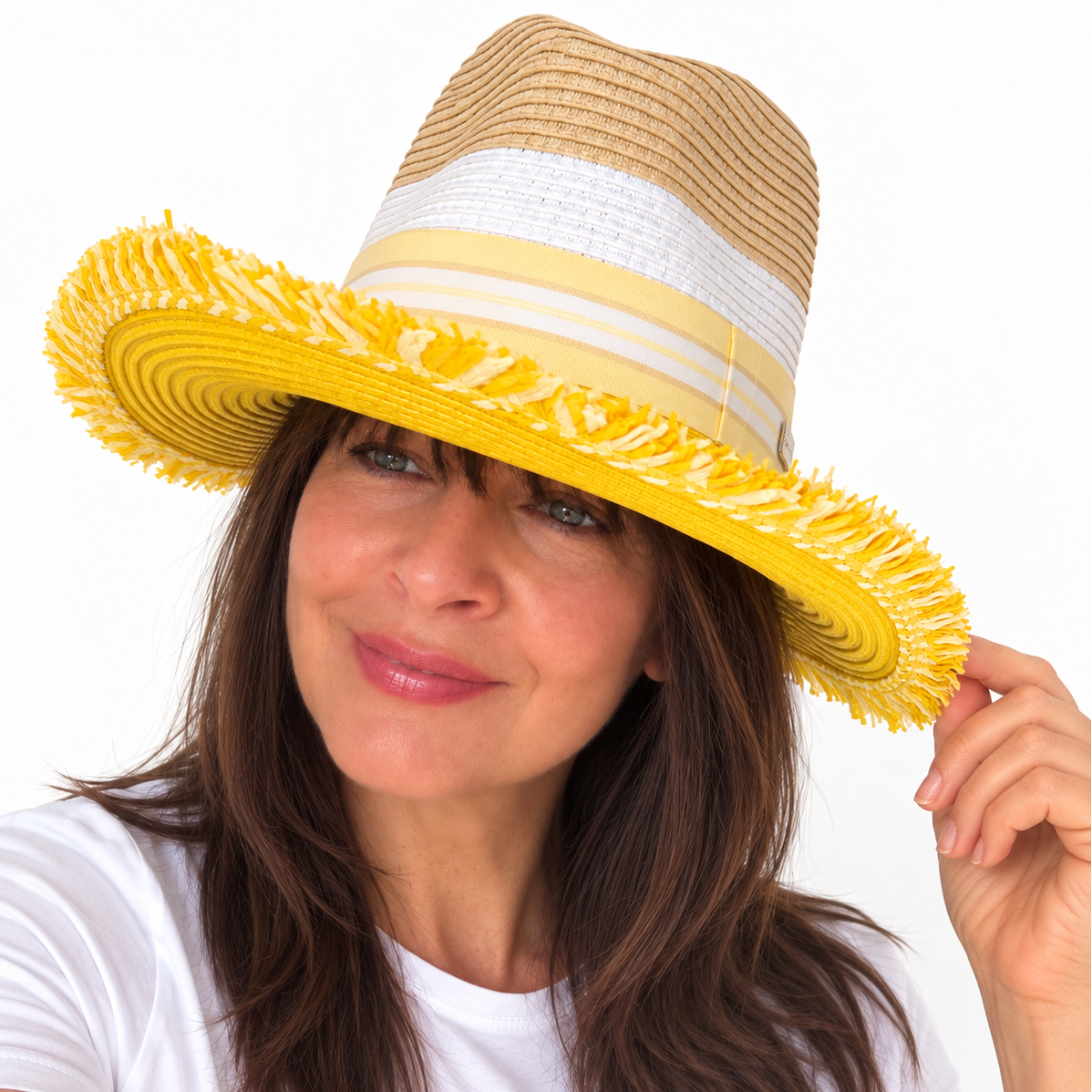Woman wearing Here Comes the Sun with Bangs yellow and natural paper hat, holding the brim