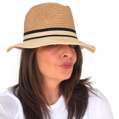 NATURALLY tan woven paper sun hat with curved brim and black and cream band worn by woman
