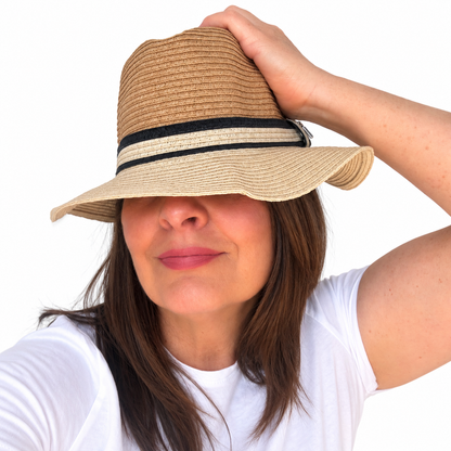 NATURALLY tan woven paper hat with black and cream band worn by brunette woman against white background