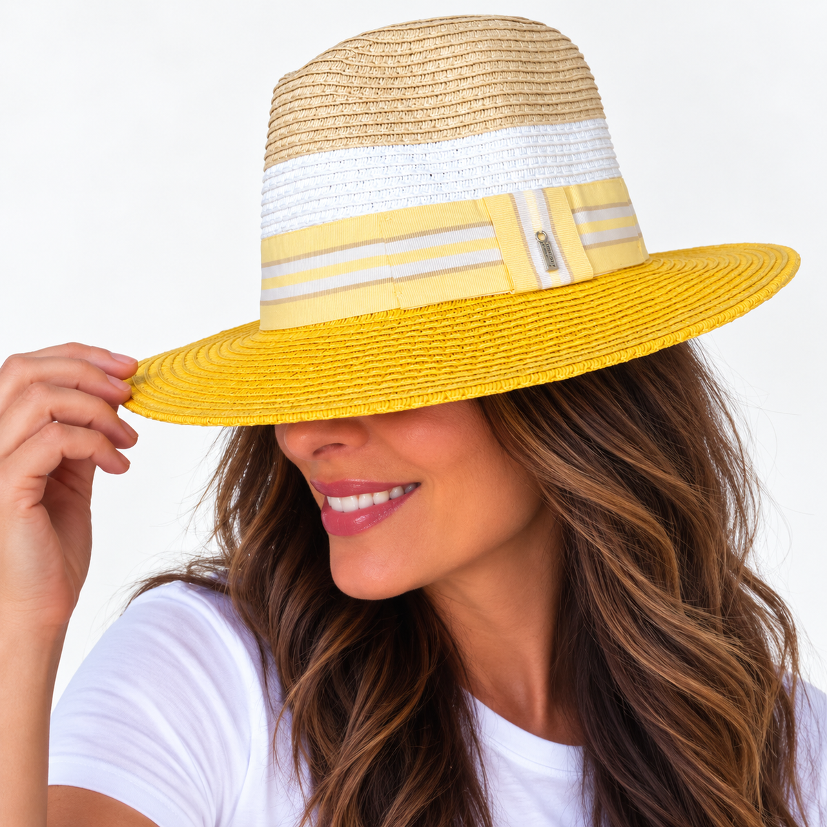 Woman wearing Here Comes The Sun yellow and natural sun hat, smiling