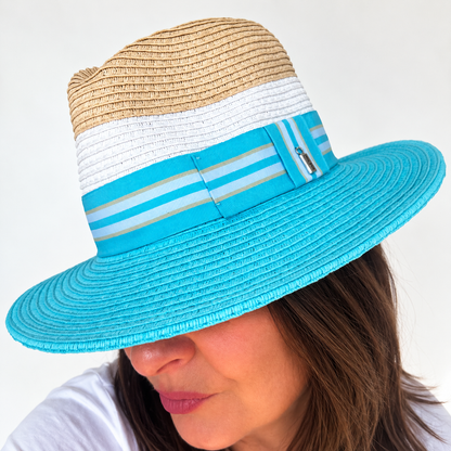 Woman wearing Dive Right In blue and natural sun hat, looking down