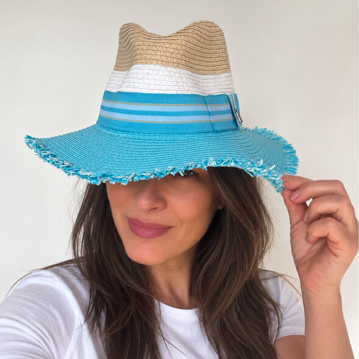 Dive Right In with Bangs woven sun hat worn by woman with wide turquoise frayed brim