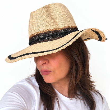 As I Am natural handwoven paper hat with black trim worn by woman, side view