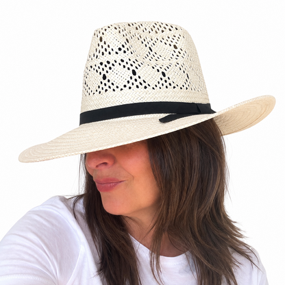 LOVELACE ivory woven hat with black band worn by brunette woman against white background