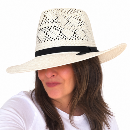 LOVELACE ivory open-weave straw hat with black band and wide brim worn by brunette woman