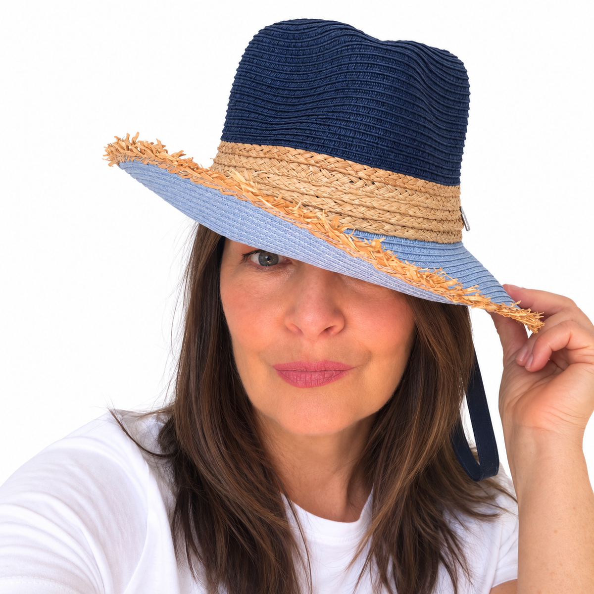 Baby Blues navy and blue woven hat with frayed brim worn by woman touching the brim
